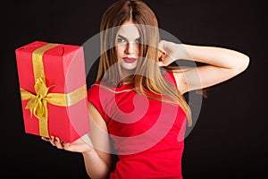 Pretty girl is holding gift box, Christmas time