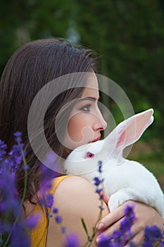 Pretty girl holding a white bunny