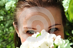 Pretty girl Inhales aroma of flower