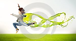 Pretty girl jumping with green abstract liquid dress