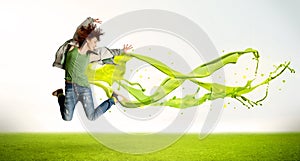 Pretty girl jumping with green abstract liquid dress