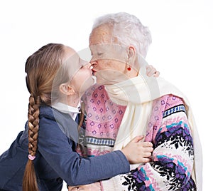 Pretty girl kissing her grandmother