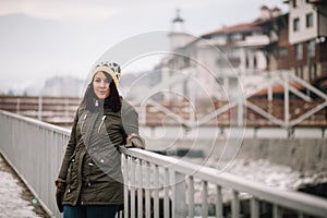 Pretty girl leaning on a bridge railings