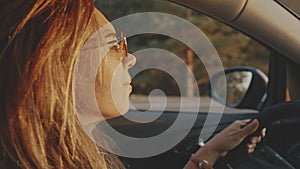 Pretty girl listening to calm music and relaxing while travelling. Close-up of adorable young blonde face wearing