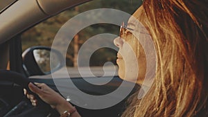 Pretty girl listening to calm music and relaxing while travelling. Close-up of adorable young blonde face wearing