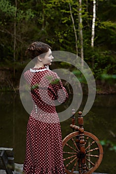 Pretty girl in long dress at the deep dark forest