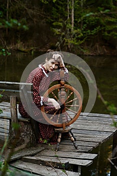 Pretty girl in long dress at the deep dark forest