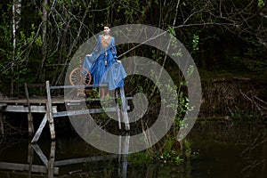 Pretty girl in long dress at the deep dark forest