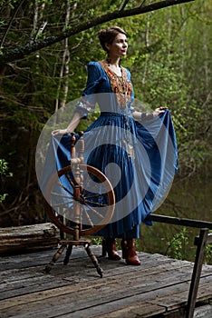 Pretty girl in long dress at the deep dark forest