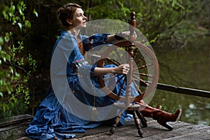 Pretty girl in long dress at the deep dark forest