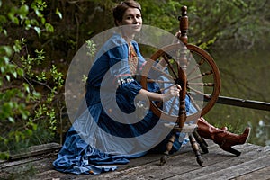 Pretty girl in long dress at the deep dark forest