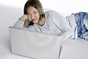 Pretty girl looking happy with a laptop computer