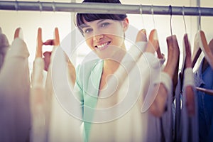 Pretty girl looking trough the wardrobe