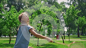 Pretty girl playing badminton on nature close up. Sporty child enjoy game.
