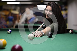 Pretty girl playing billiard