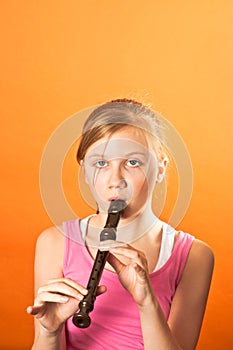 Pretty girl playing the recorder