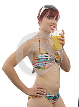 Pretty girl posing in bikini, drink orange juice, on white background