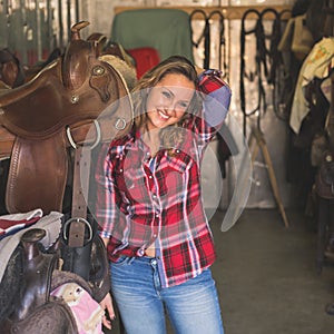 Pretty girl posing in equestrian context