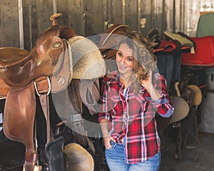 Pretty girl posing in equestrian context
