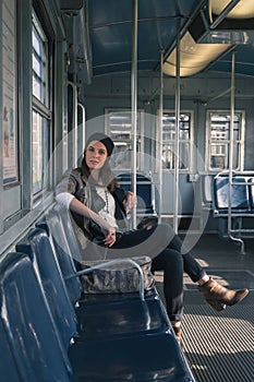 Pretty girl posing in a metro car