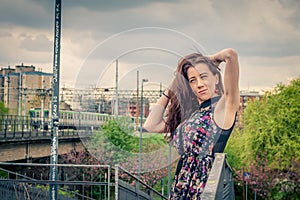 Pretty girl posing on railroad bridge