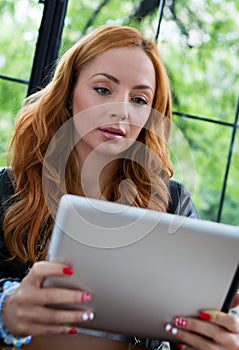 Pretty girl posing with a tablet