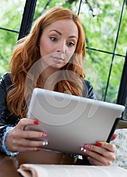 Pretty girl posing with a tablet