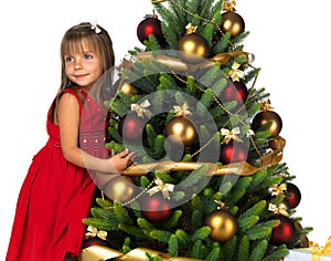 Pretty girl with present near the Christmas tree