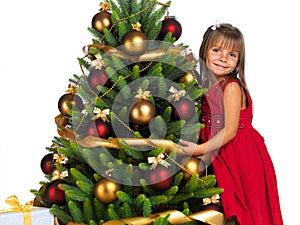 Pretty girl with present near the Cristmas tree