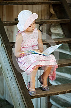 Pretty girl is reading a children's book