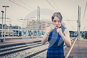 Pretty girl ready to fight along the tracks