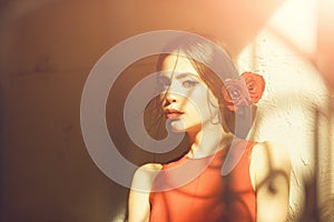 Pretty girl in red dress and roses in hair