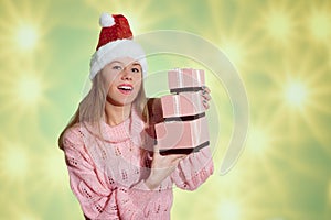 Pretty girl in red Santa hat holding pink gift