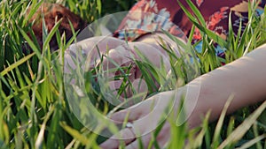 Pretty girl relaxing outdoor in green grass