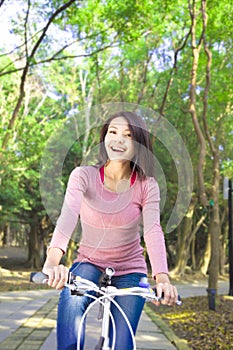 Pretty girl riding a bike and enjoy free time