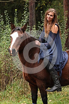 Pretty girl riding a horse without any equipment