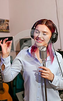 Pretty Girl Singing Into Studio Microphone.