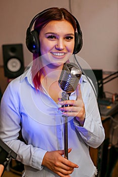 Pretty Girl Singing Into Studio Microphone.