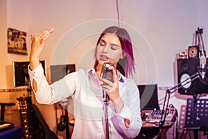 Pretty Girl Singing Into Studio Microphone.