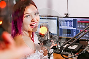 Pretty Girl Singing Into Studio Microphone.