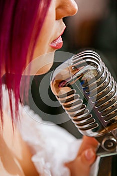 Pretty Girl Singing Into Studio Microphone.