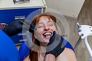 Pretty girl smiling at the dentist