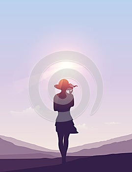 Pretty girl with summer hat silhouette at sunny summer sky background