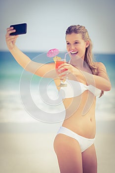 Pretty girl in swimsuit taking a selfie