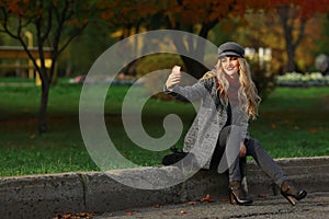 Pretty girl take a self portrait with her smart phone in autumn park