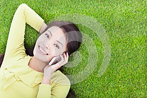 Pretty girl talking over the phone in a meadow