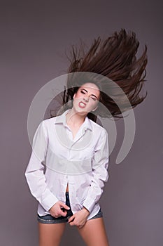 Pretty girl teenager jumping at studio expressing happiness