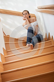 Pretty girl thinking at staircase