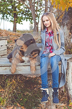 Pretty girl with tibetan mastiff on the nature