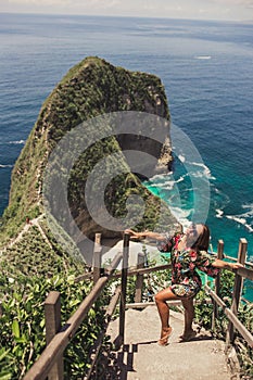 Pretty girl is traveling on kelingking bay, the island of Nusa Penida, Indonesia